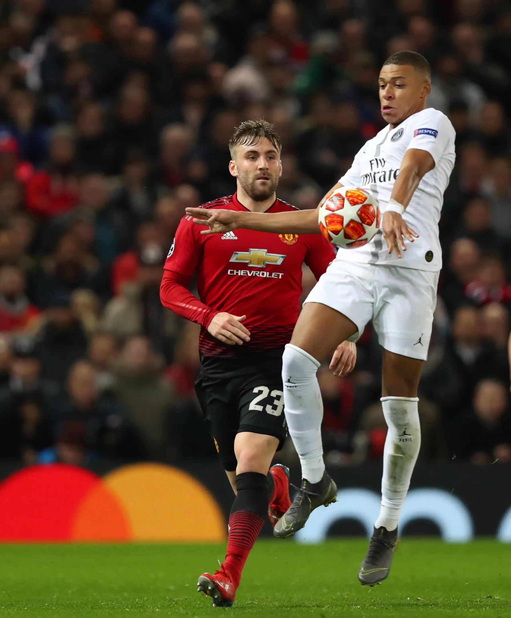 Kylian Mbappe (white) and Luke Shaw (red) During Champions League match